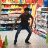 a blurry picture of a man dancing in a store with a few cones in the foreground