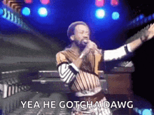 a man singing into a microphone with the words yea he gotcha dawg