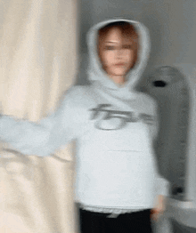 a blurry picture of a person wearing a hoodie with the letter f on the front