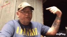 a man wearing a blue shirt that says nirvana on it