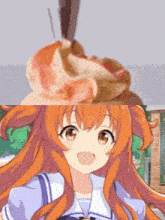 a girl with long orange hair is smiling next to a cupcake on a table