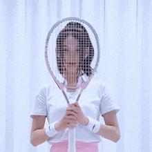 a woman with a tennis racquet in front of her face