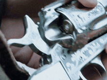 a close up of a person holding a gun that says ' smith & wesson ' on the barrel