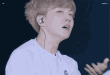 a close up of a person wearing headphones and a white shirt .