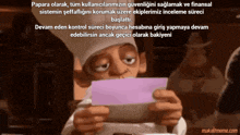 a man in a chef 's hat is holding a piece of paper
