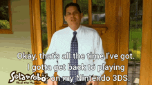 a man in a white shirt and tie is holding a nintendo 3ds game