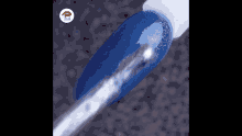 a close up of a nail with blue nail polish and a silver brush .