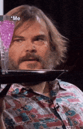 a man with a beard is holding a tray with a purple drink on it and the word me on the bottom
