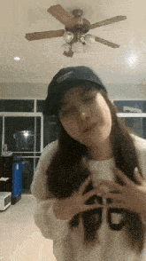 a woman wearing a hat and a sweater with the letter g on it