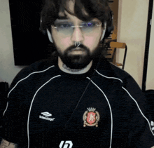 a man with a beard is wearing a shirt that says balenciaga on it