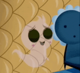 a cartoon character with sunglasses on is standing next to a blue chair .