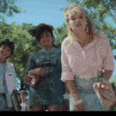 a girl in a pink shirt is standing next to a boy in a white jacket