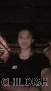 a person standing under a bunk bed with the word childish on the bottom right