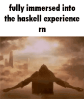 a silhouette of a man with his arms outstretched in front of a cloudy sky .