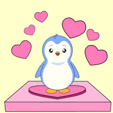 a blue and white penguin is standing on a pink heart shaped box