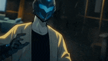 a man in a futuristic helmet is holding a microphone .