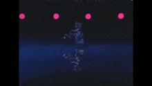 a person riding a bike in a dark room with pink lights