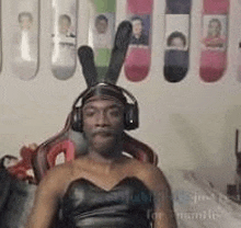 a man is wearing a bunny costume and headphones while sitting in a chair .