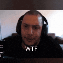a man wearing headphones with the word wtf written on his face