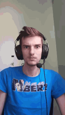 a man wearing headphones and a blue shirt that says ' amber '