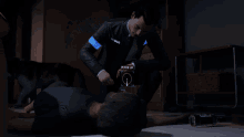 a man with a beard and a black shirt is laying on the floor
