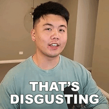 a man in a blue shirt is holding a microphone and says that 's disgusting .