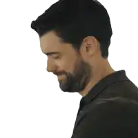 a man with a beard wearing a black polo shirt