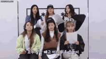 a group of girls are posing for a picture and one of them is wearing a hat that says brooklyn on it