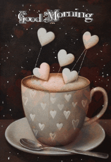 a cup of coffee with hearts in it and the words good morning written on the bottom