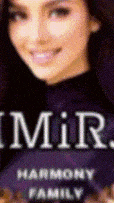a woman is smiling in front of a harmony family sign