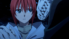 a girl with red hair looks at a skeleton