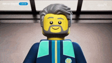 a lego man with a beard and a blue jacket is smiling