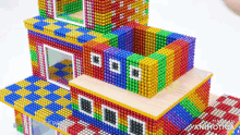 a rainbow colored building made out of magnets with the words made in animatica on the bottom