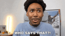a man in a blue sweater says " who says that ? "