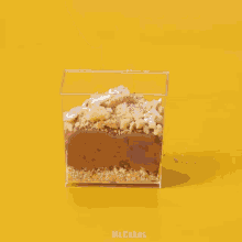 a person is putting candy on top of a dessert in a clear container
