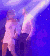 a man and woman are dancing in a dark room
