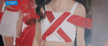 a woman in a red and white top with an x on her chest