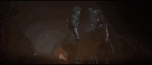 a woman in a hooded jacket is looking at a man in the dark .
