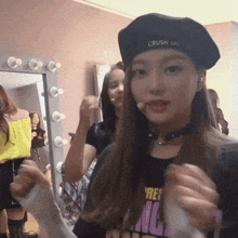 a woman wearing a hat that says crush on it stands in front of a mirror