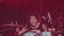 a person wearing a black tank top that says one ok rock on it