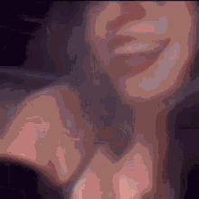 a close up of a woman 's face with a smile on her face