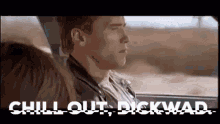 a man is sitting in a car with a woman and the words `` chill out , dickwad '' written above him .