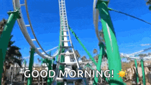 a roller coaster at a theme park with the words `` good morning '' written on it .