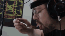 a man wearing headphones and a headband is eating something with a spoon