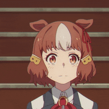 a close up of a girl with the letter b on her head