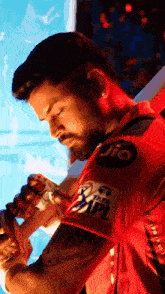 a man in a red shirt with jio written on the sleeve