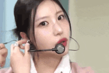 a close up of a woman wearing a microphone and headphones .