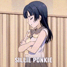 a girl is standing in front of a curtain with her arms crossed and the words sillie ponkie written above her .