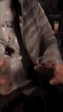 a man is holding a glass of wine in his hand
