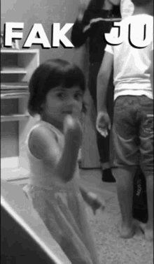 a black and white photo of a little girl with the words " fak ju " written above her